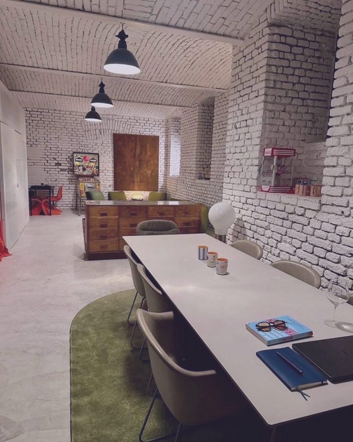 The long communal table and brick arches at House of Vision