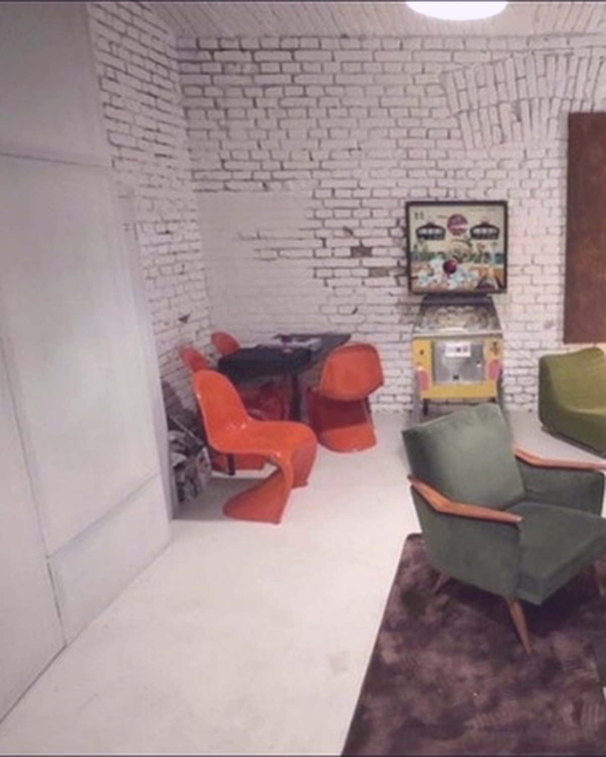 The House of Vision lounge with green chairs and a long table